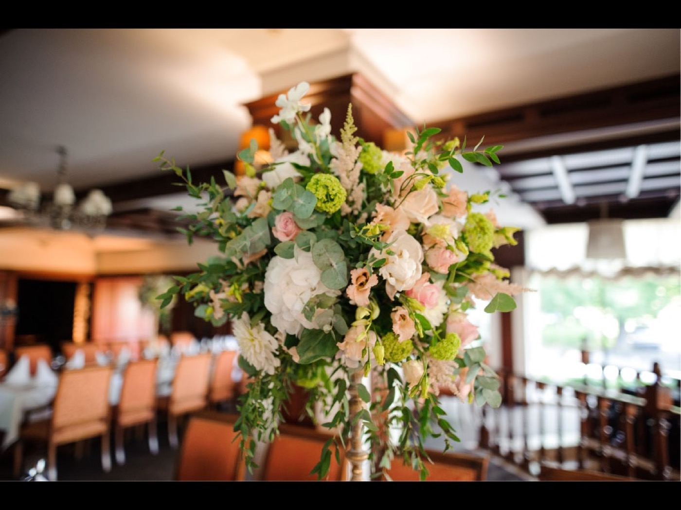 Large floral arrangement displayed in a hotel-style lobby.
